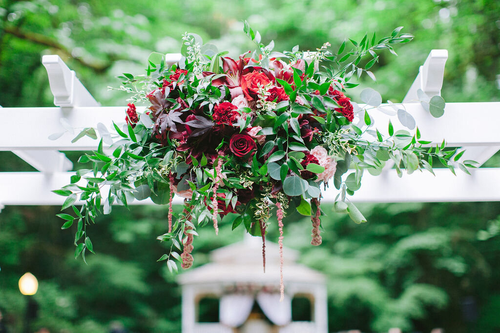 Burgundy flowers to adorn the trellis in the veiled garden.