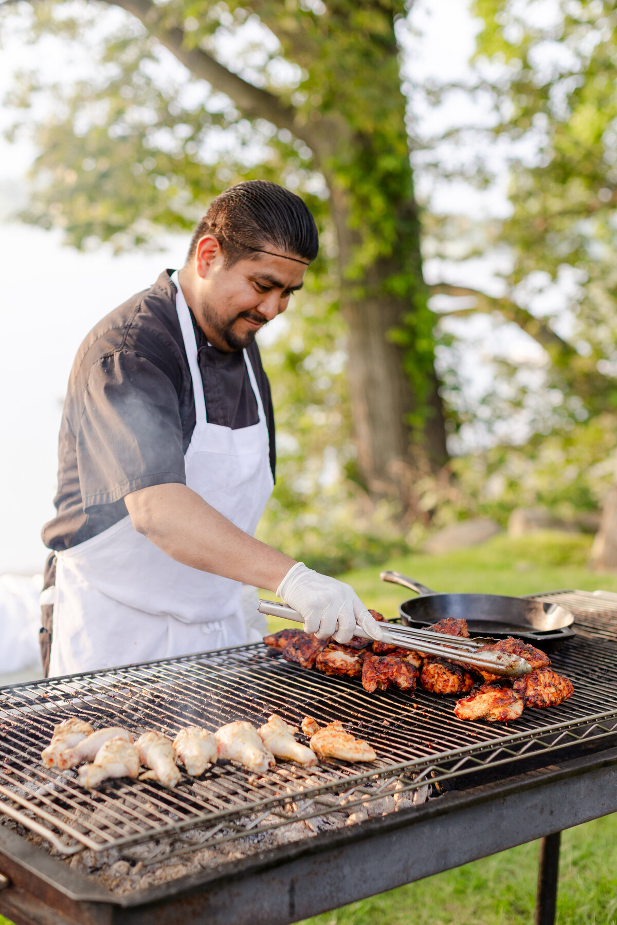 chef grilling the bbq for the "I Do BBQ" themed rehearsal dinner