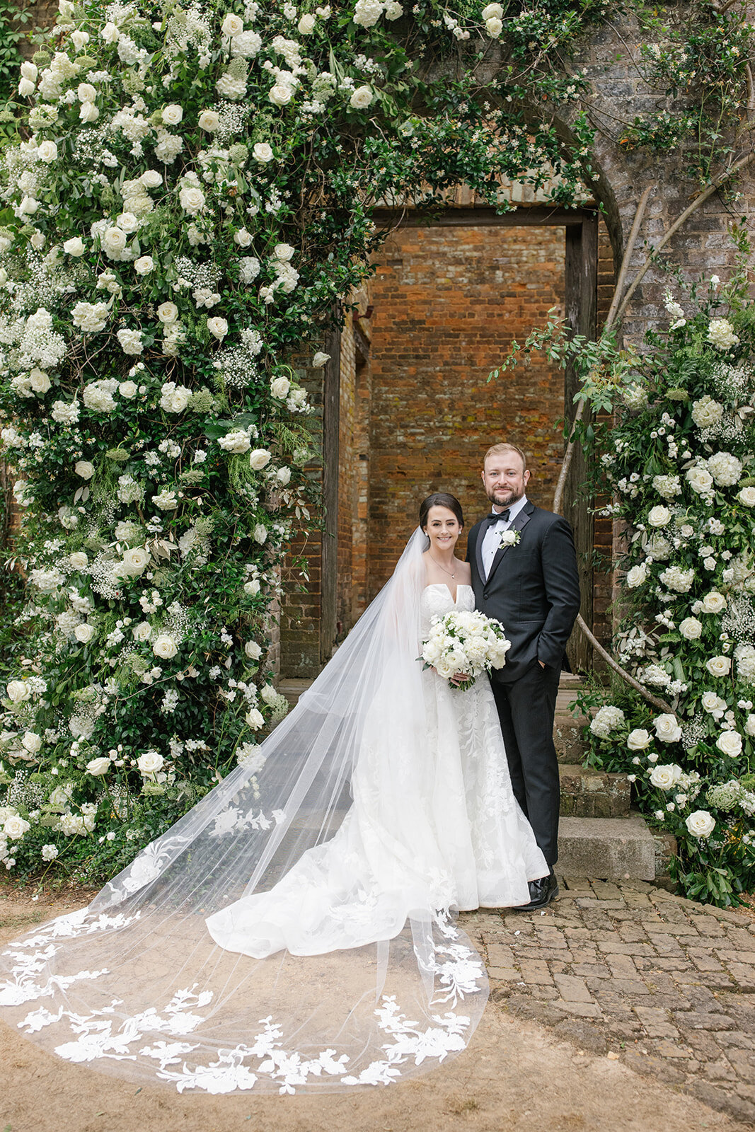 bride and groom portrait with asymetrical wedding arch