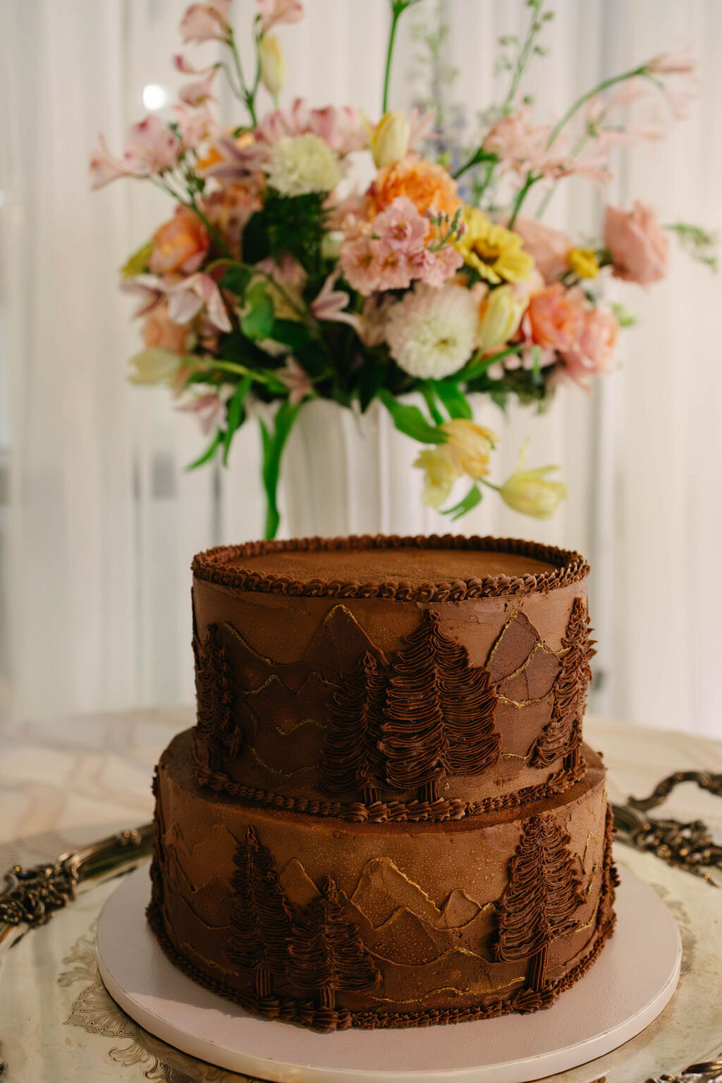 Chocolate groom’s cake with mountain and evergreen detailing displayed at The Bascom Center wedding in Highlands NC.