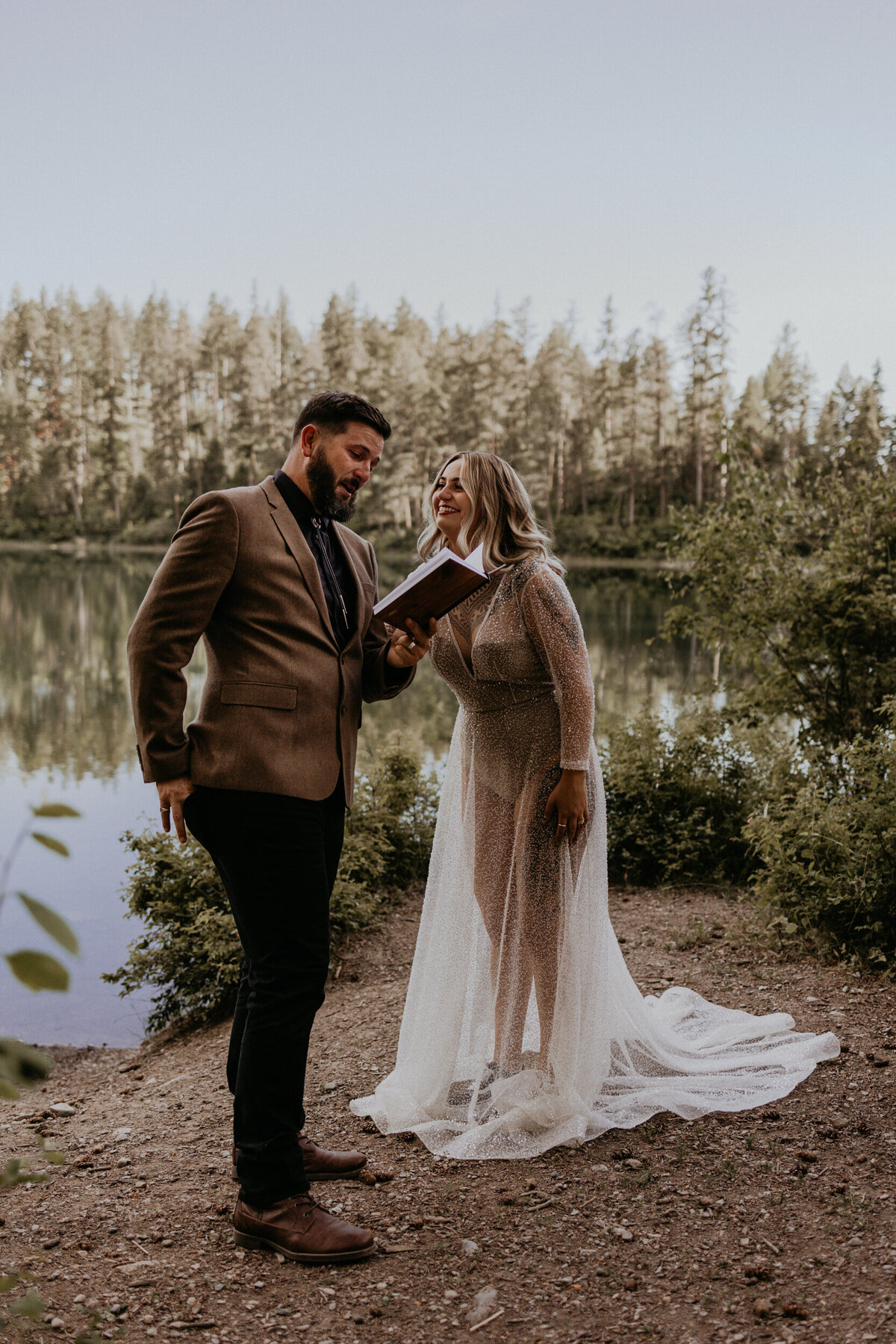 bride and groom laughing together while reading vows