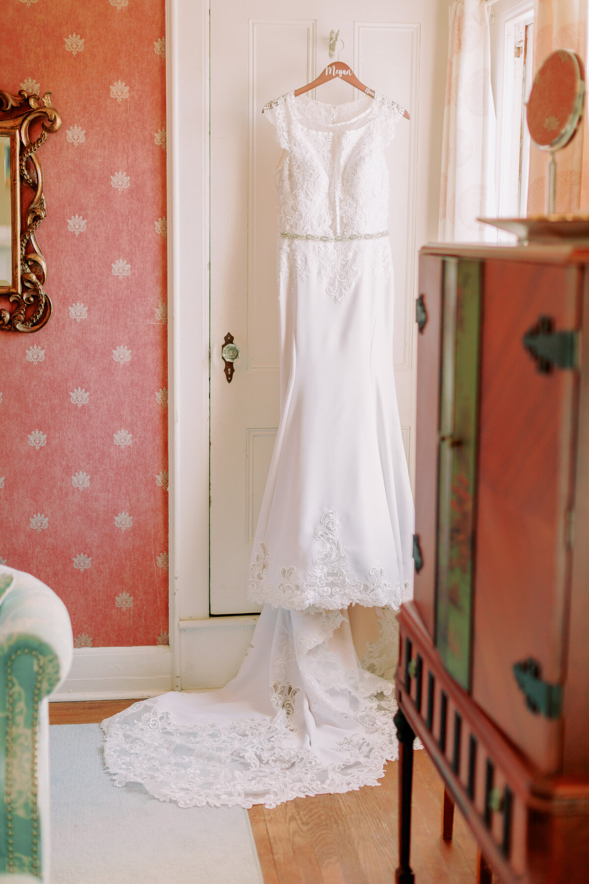A wedding dress hanging from a door 