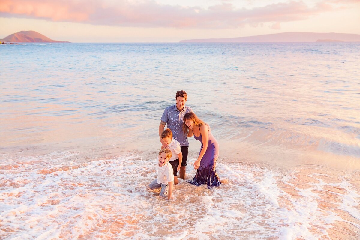 Family portrait standing in the ocean in Wailea by Love + Water