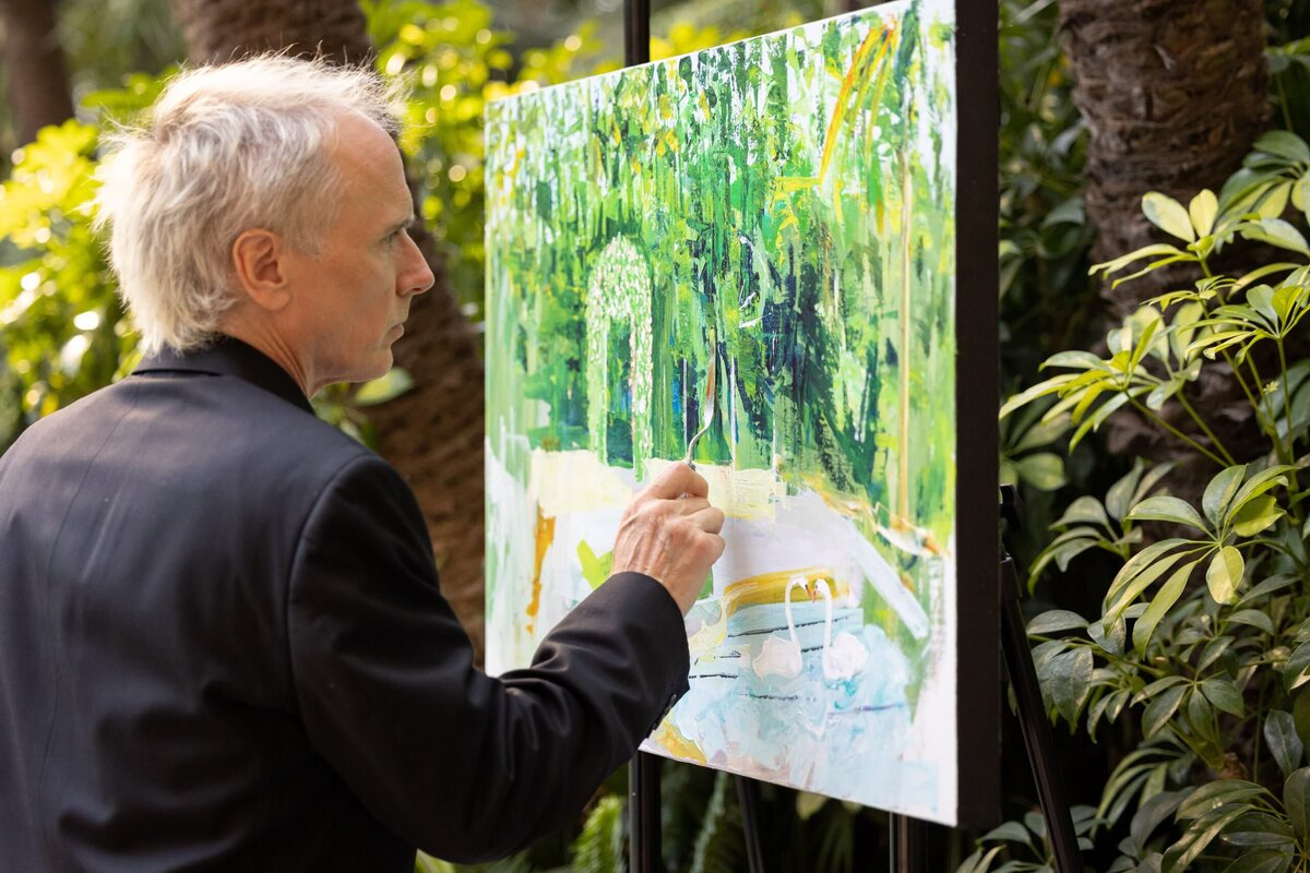 A person painting a live wedding scene.