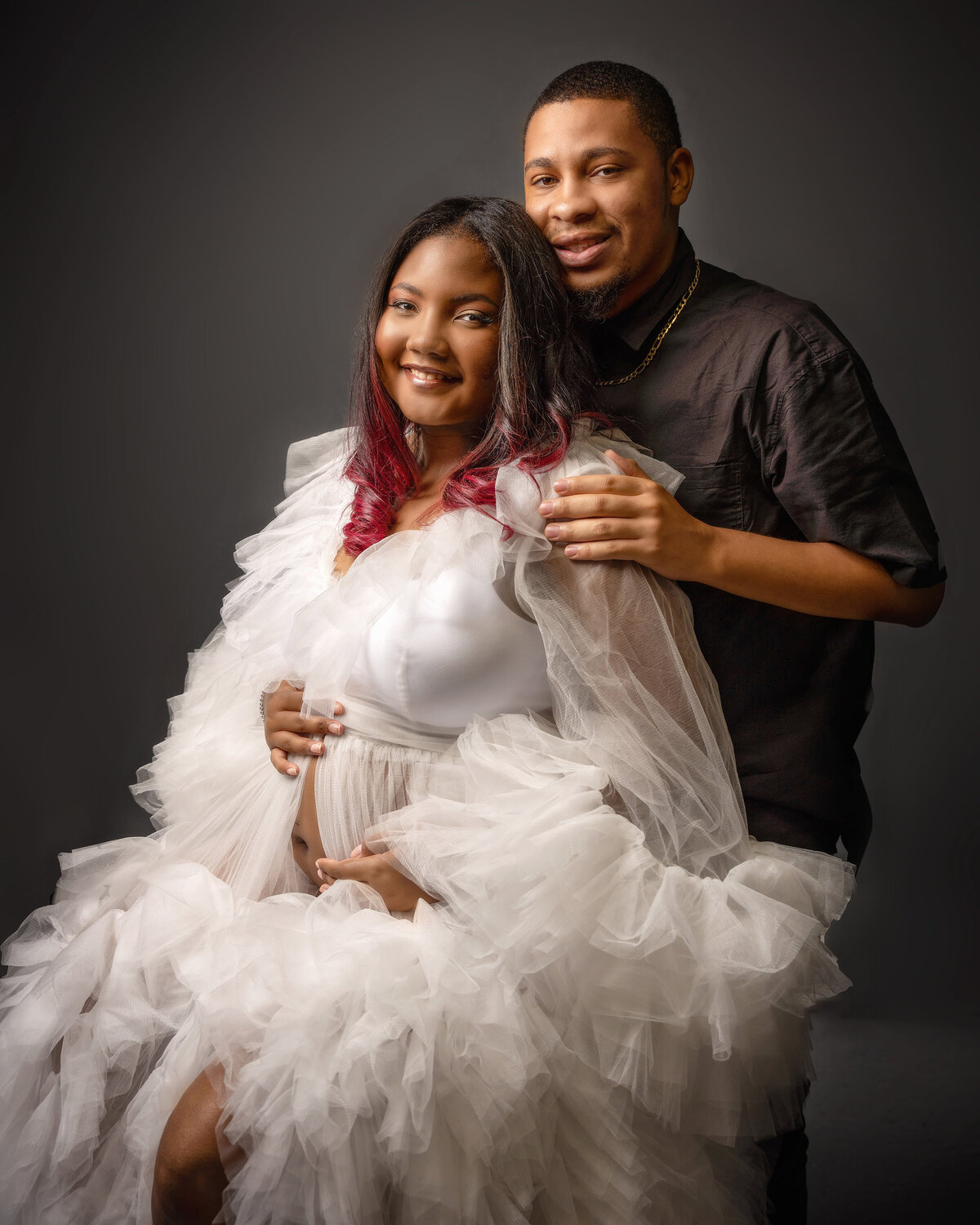 man woman white robe tulle pregnant smile studio