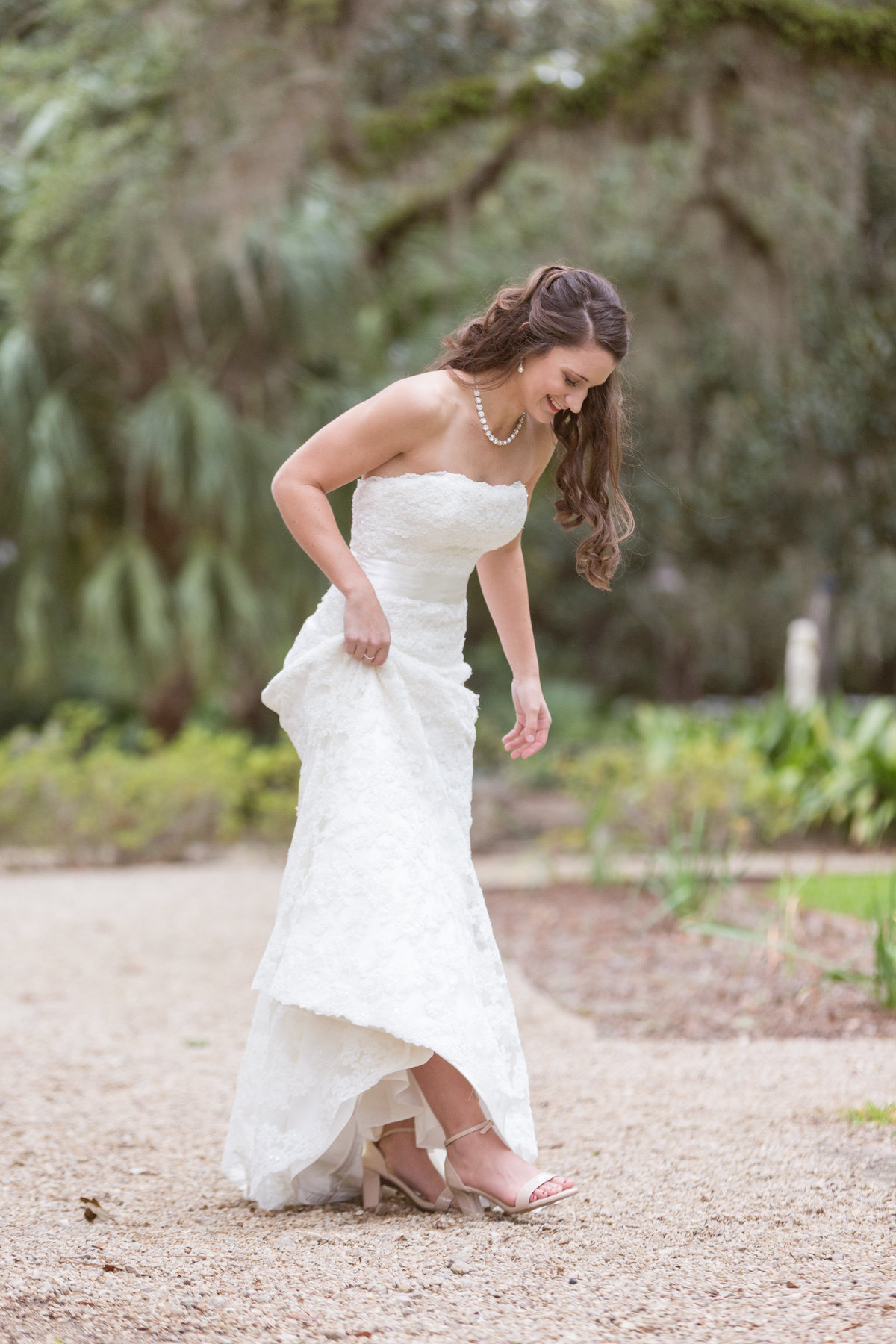 Photo of Kristen admiring her shoes during the bridal session at Goodwood House & Museum in Tallahassee, Florida..
