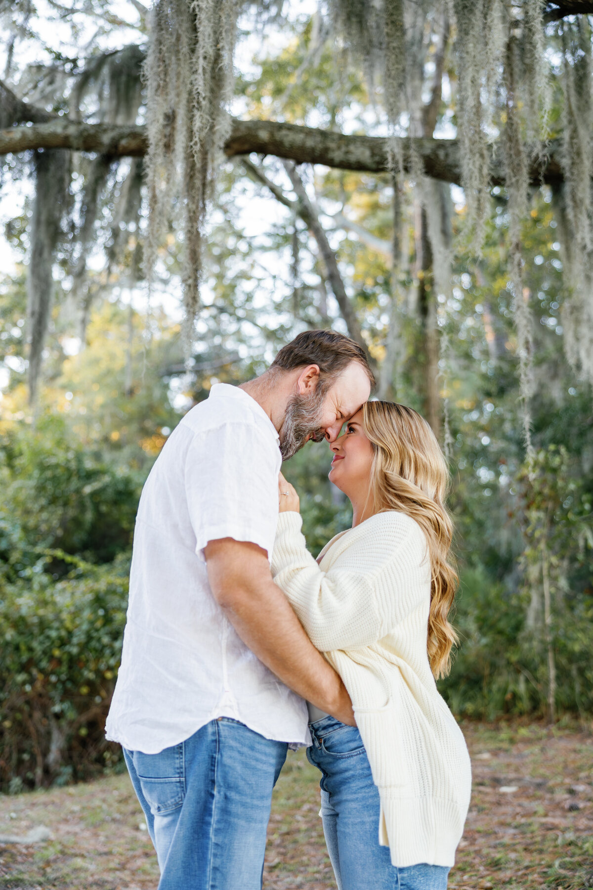 Engaged Couple in Park Holding Each Other