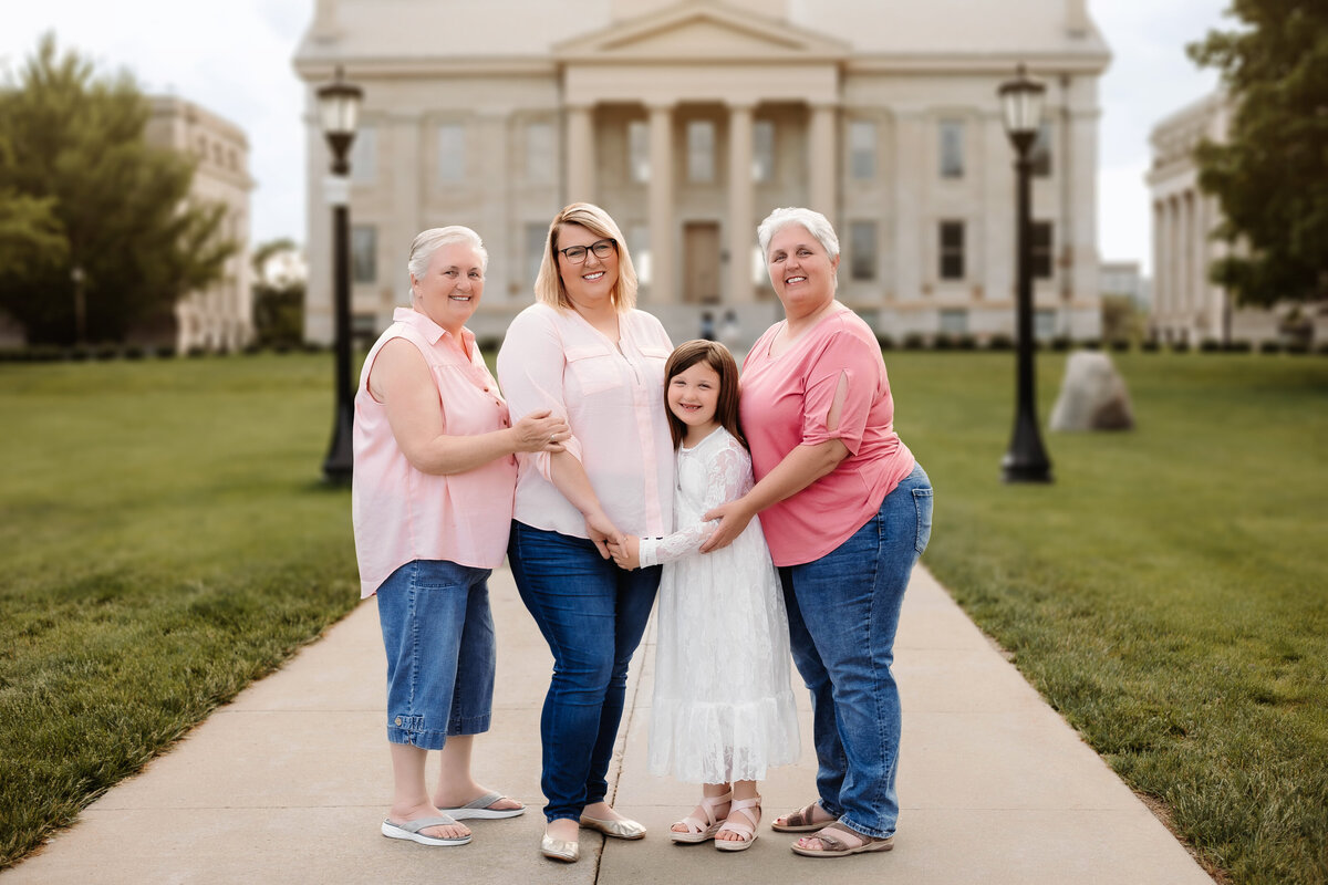 This family of four women pose in pink in Iowa City for a family session.