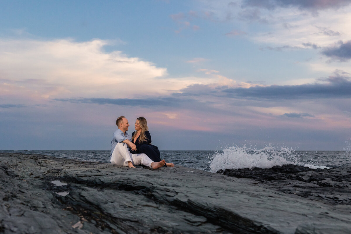 newport-engagement-couple-on-rocks-waves-sunset-lisa-gilbert-photography