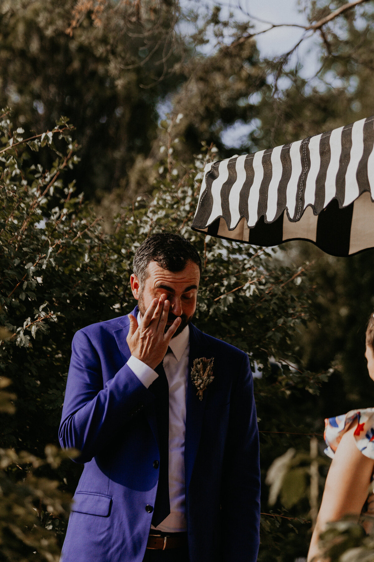 a groom crying during their wedding ceremony