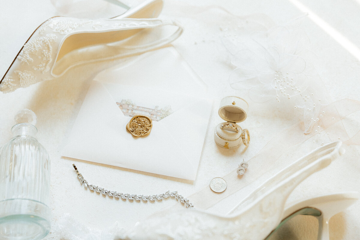 A white flat lay from a wedding at the State Game Lodge Event Barn in Custer State Park.