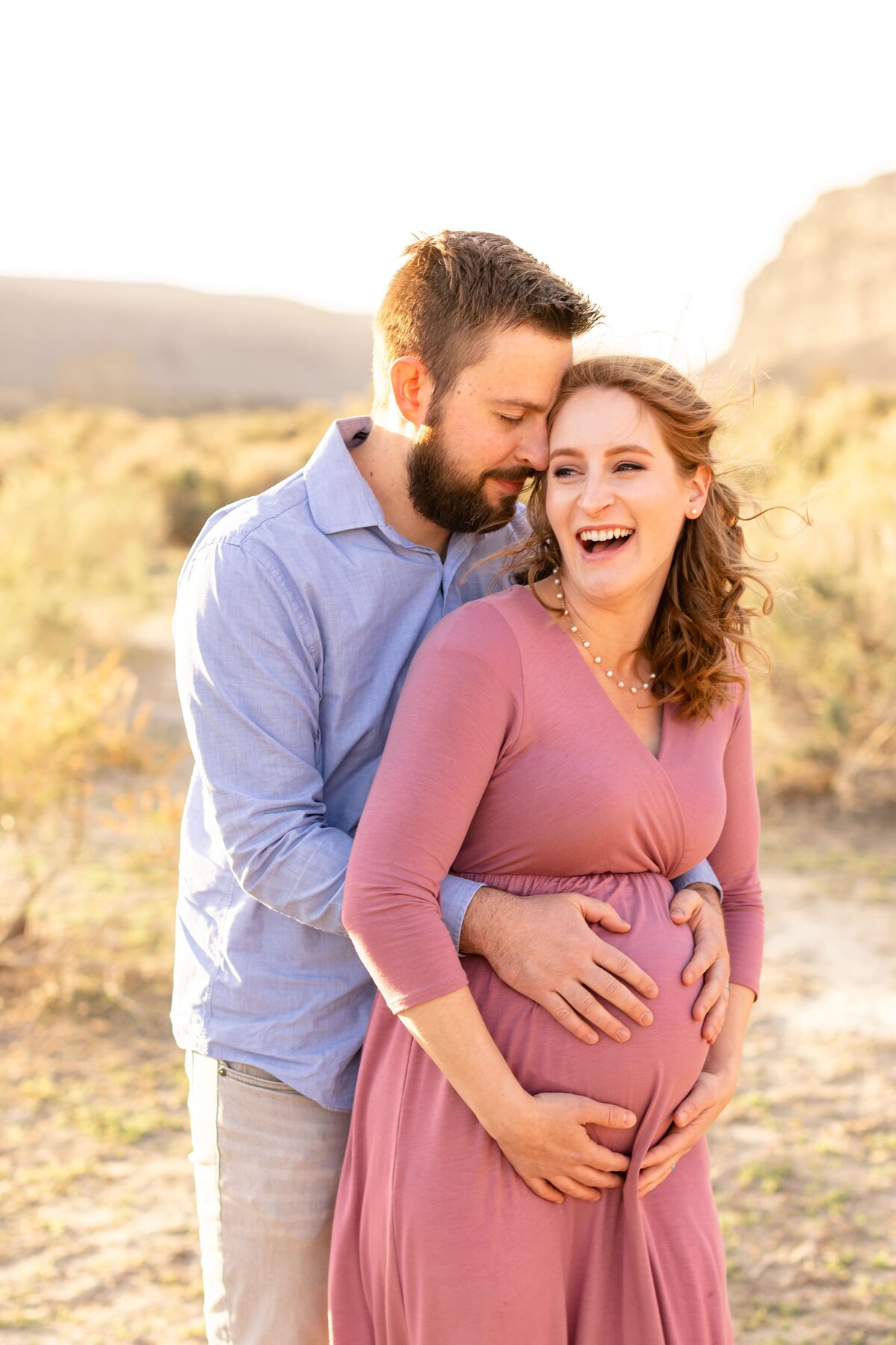 man embracing his pregnant wife