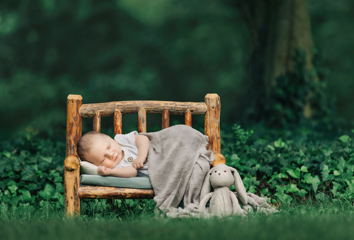 Best newborn photographer takes pictures of sleeping baby at nj photo studio.