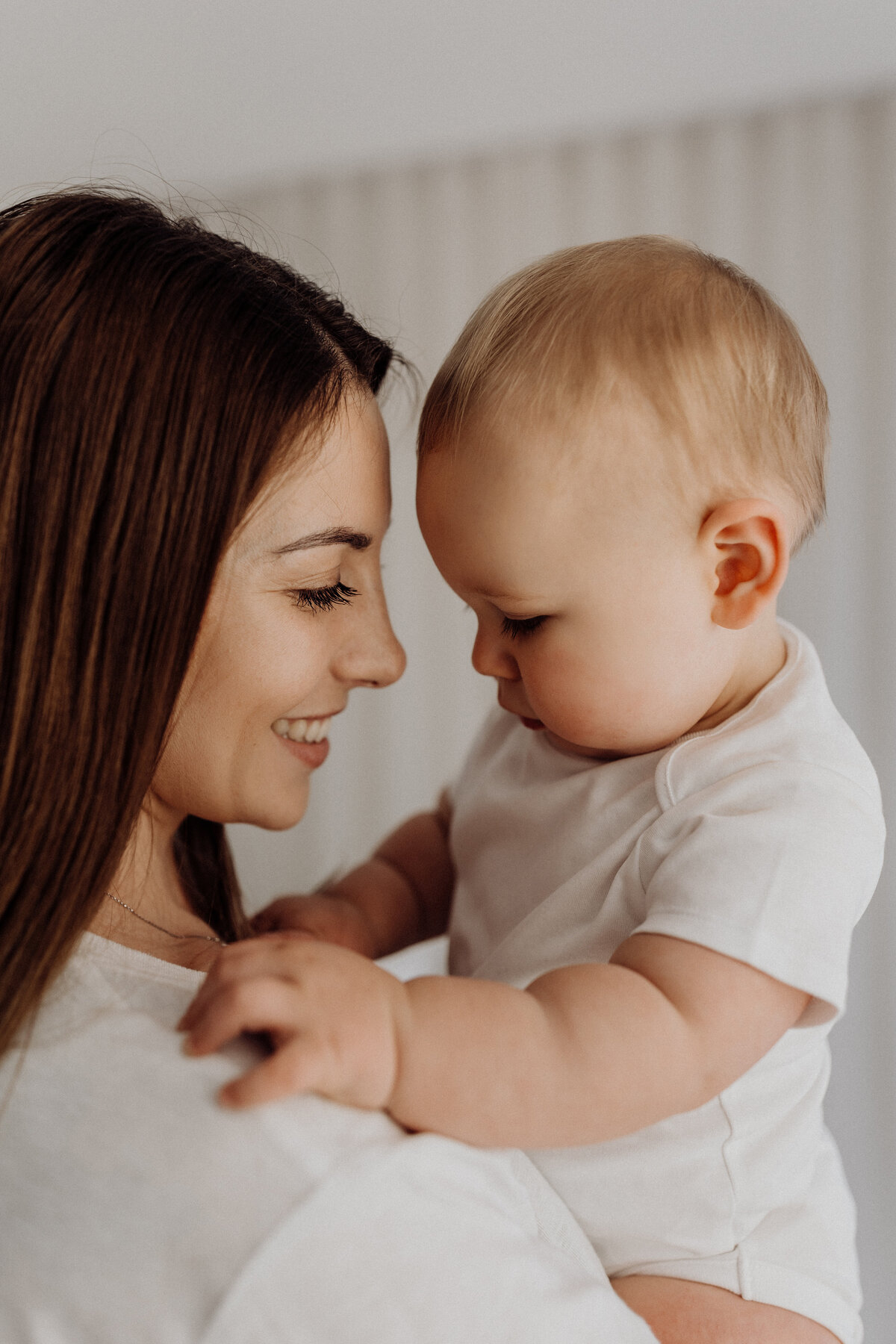 A mother looking at her baby during a baby milestone photography photoshoot in christchurch