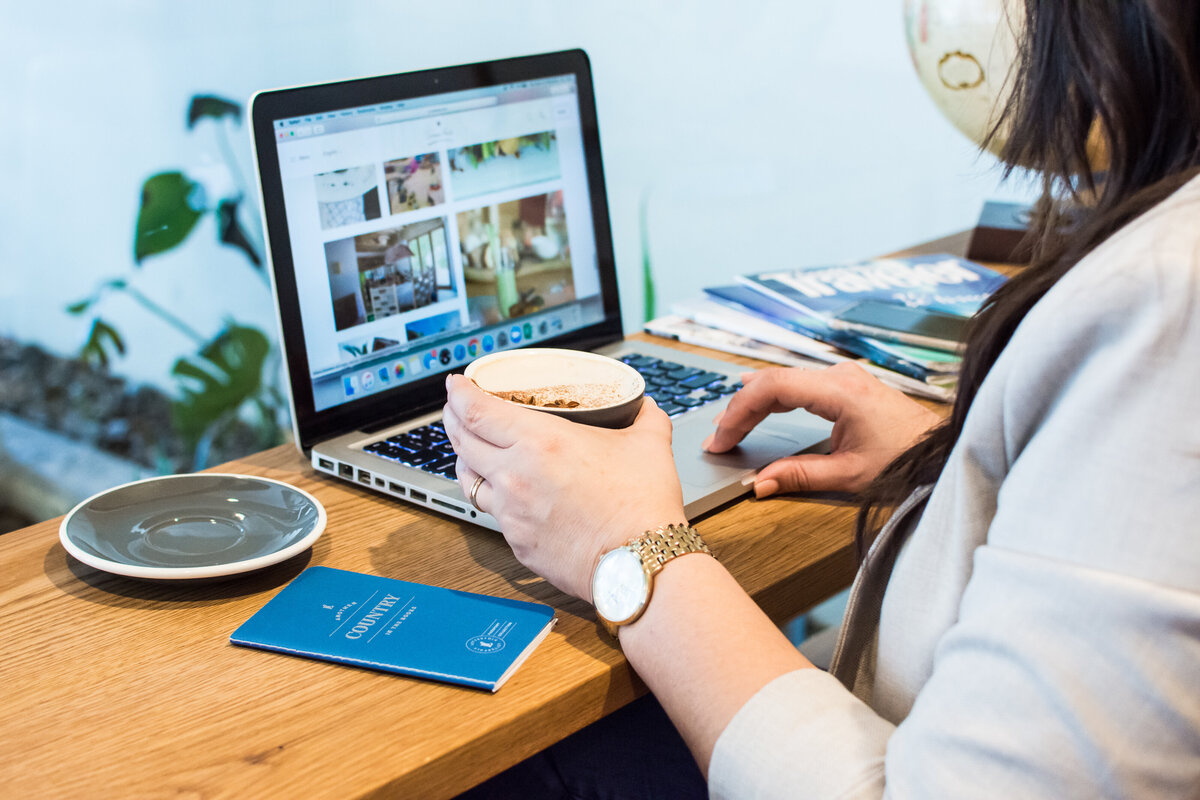 Behind the scenes image of a woman looking at a travel destination website