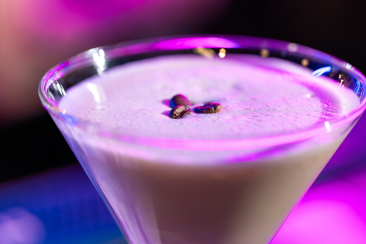 Three espresso beans in the foam of an espresso martini 