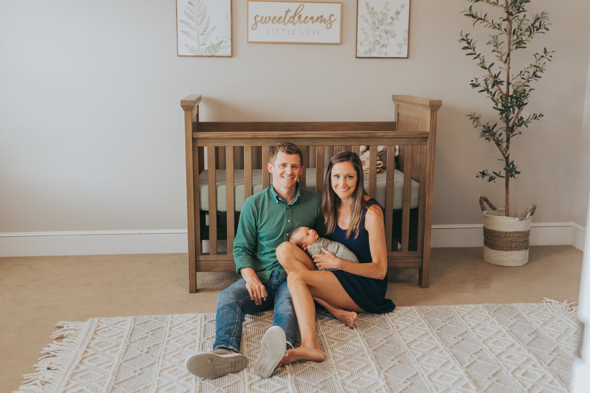 new mom and dad with newborn baby in his nursery by harrisburg pa newborn photographer