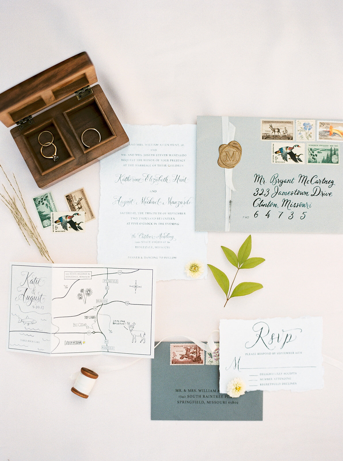 a flat lay of wedding stationery with an adventurous vibe
