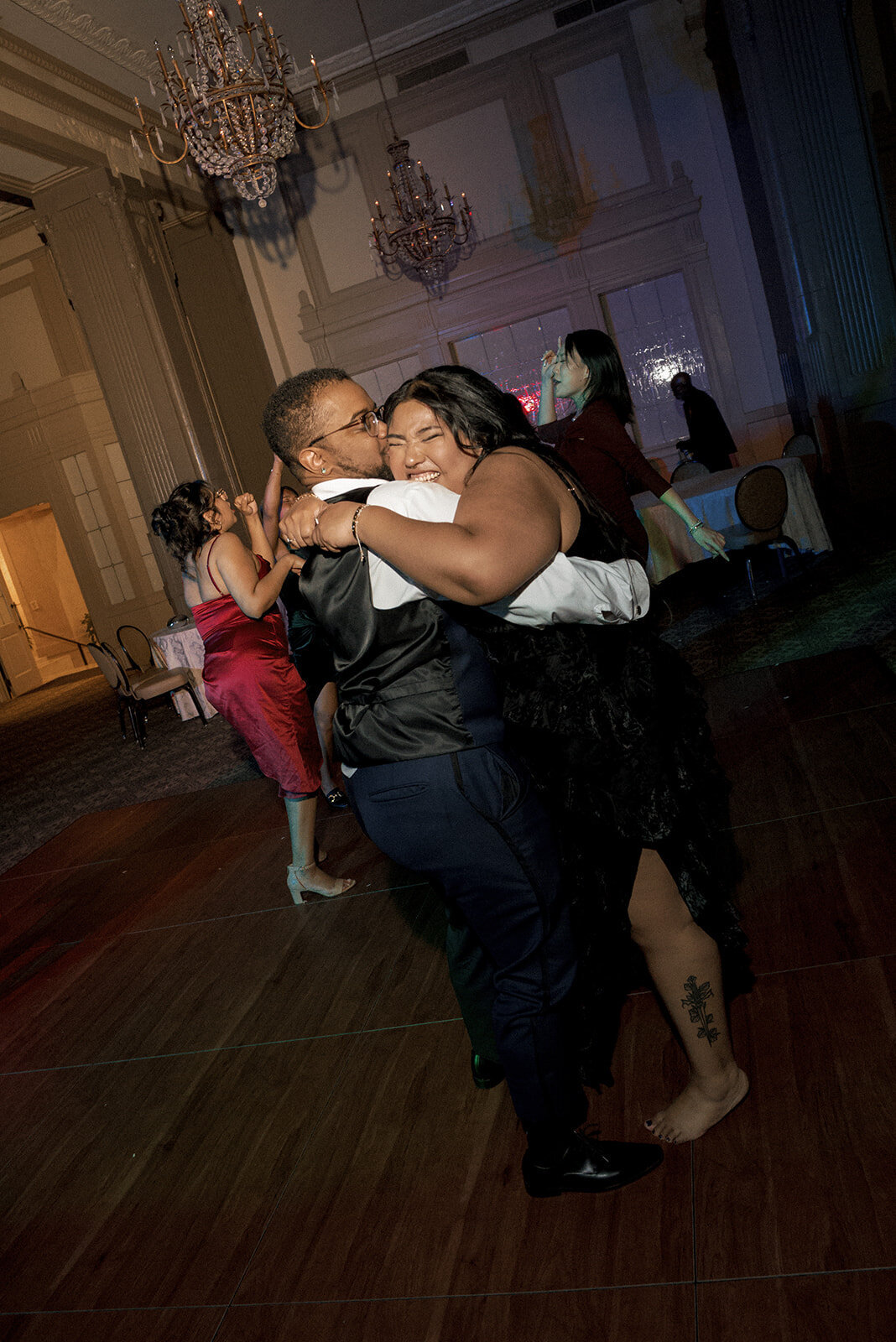 happy couple hugging wedding reception
