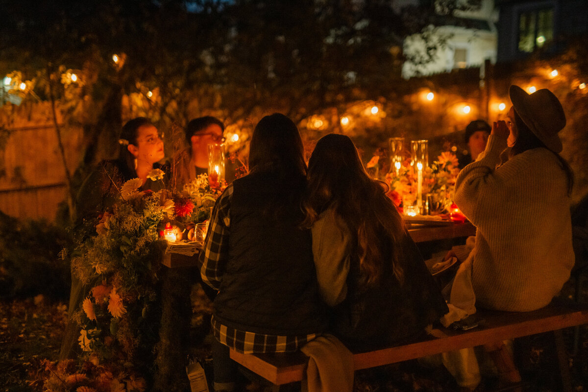 People sitting at candlelit table