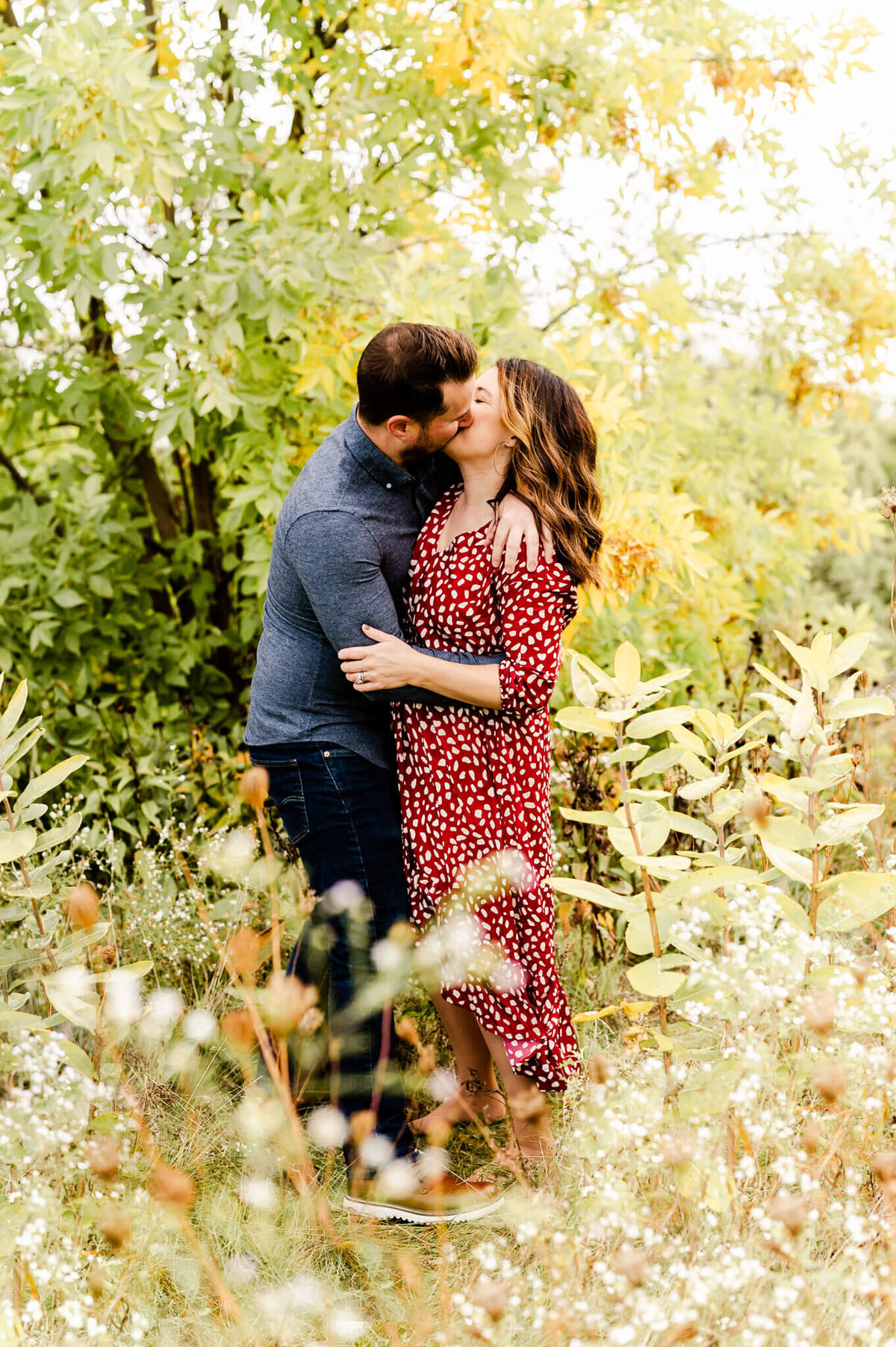 Couple kissing in wildflowers at Eldridge Park in Elmhurst, IL.