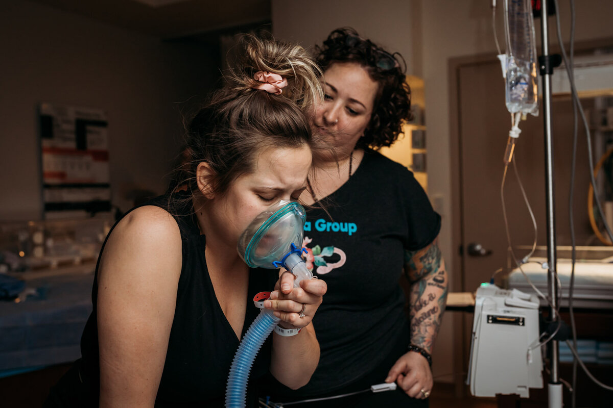 woman inhaling nitrous oxide during labor