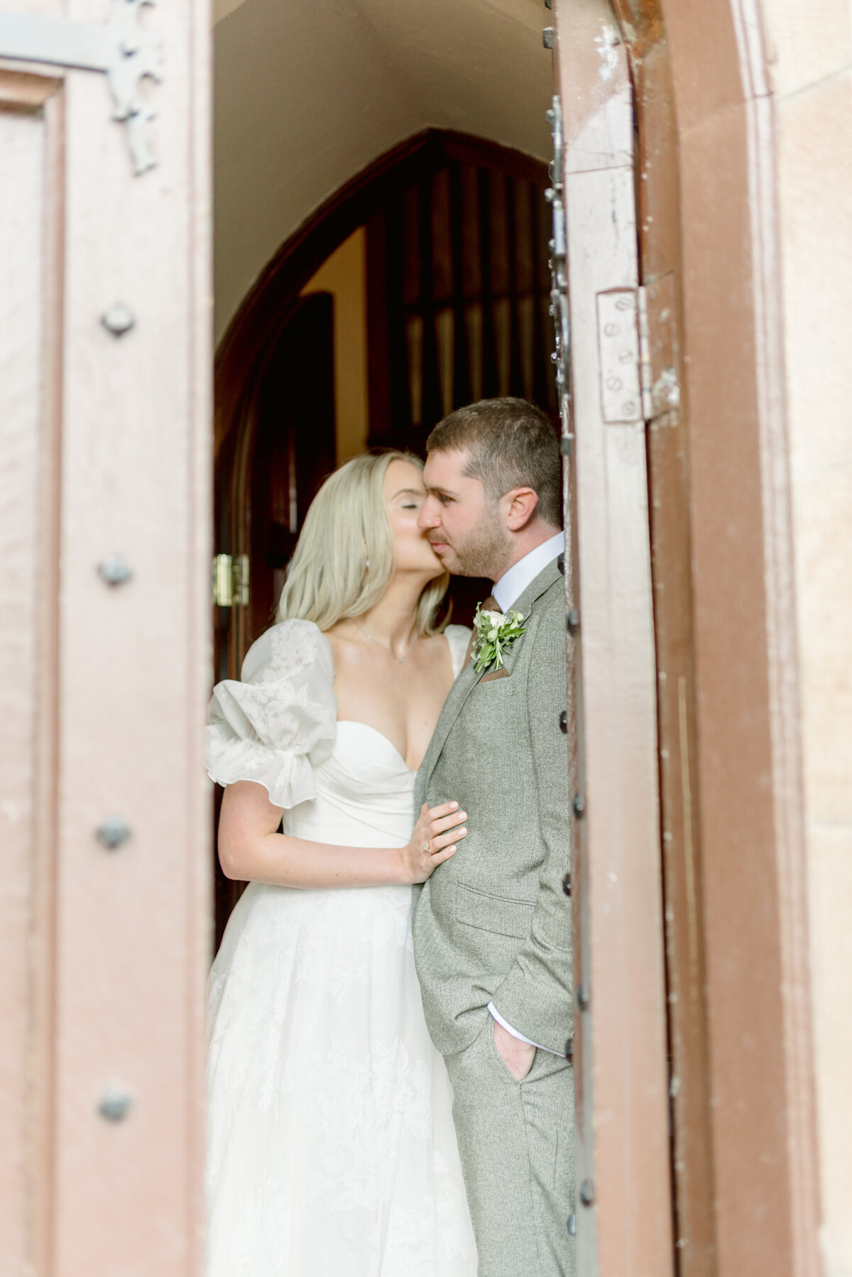 Bride and Groom in the Chapel doorway of Cromlix House, Scotland, on their summer wedding day, photographed by fine art wedding photographer UK, Jill Cherry Porter.