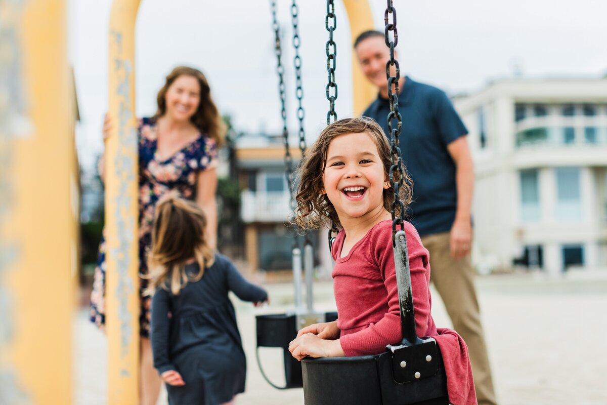 girl-on-longellow-hermosa-beach-swings-laughing