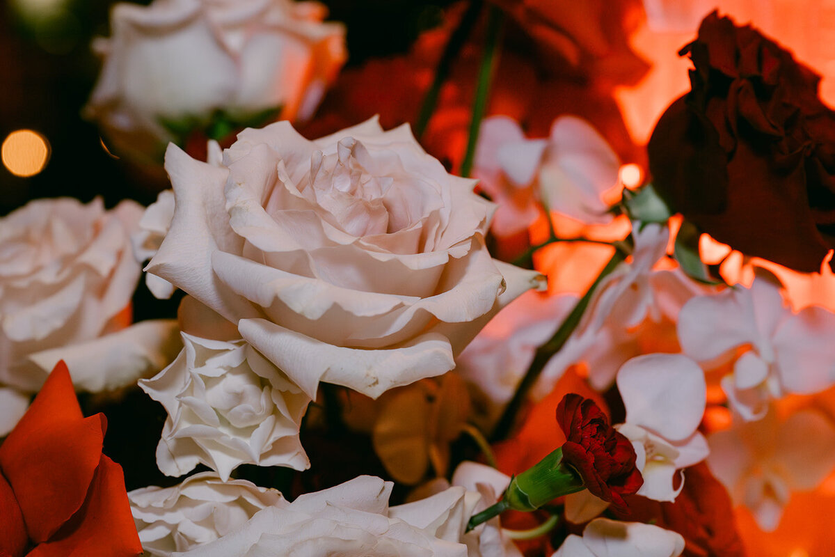 Delicate white rose surrounded by warm candlelight in fine art reception styling at luxury San Antonio venue