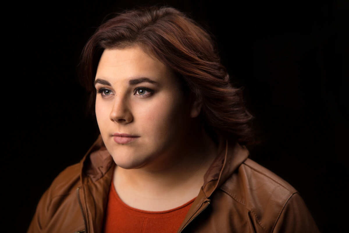 Portrait of senior girl wearing brown leather shirt in Utah County.