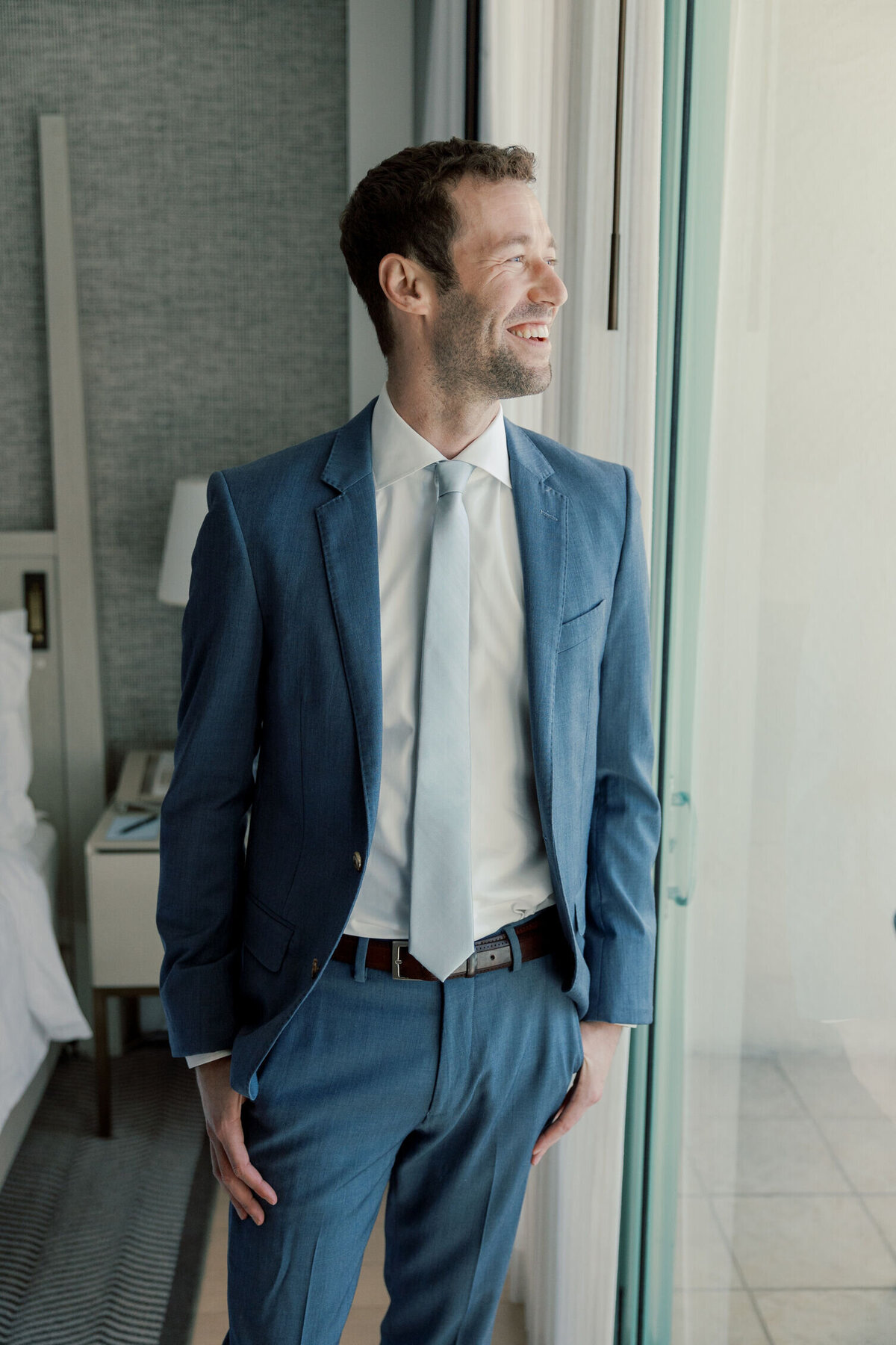 groom-smiling-looking-window-7HM-W