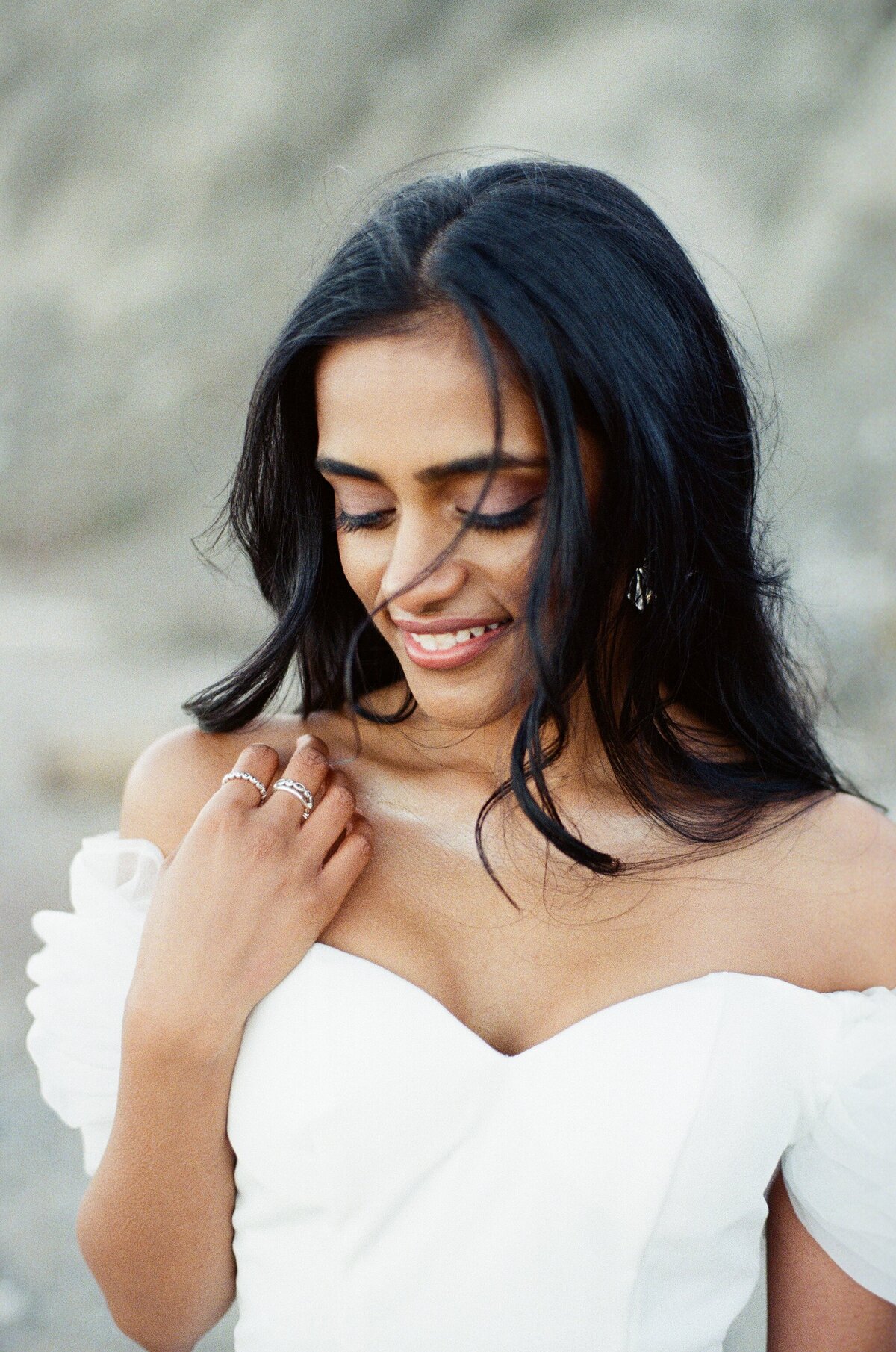 The gentle breeze caresses the bride's face during her couple portrait session with Toronto wedding photographer.