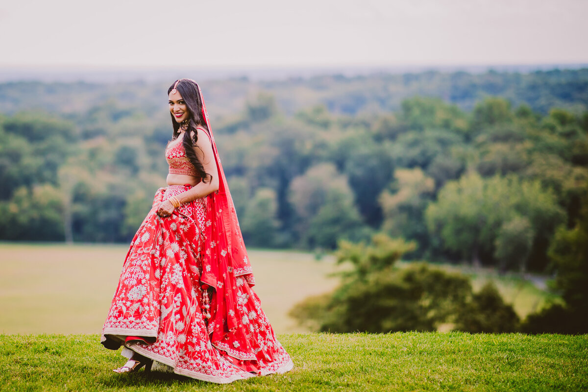 Indian bride smiling and walking near the natirar mansion overlooking new jersey