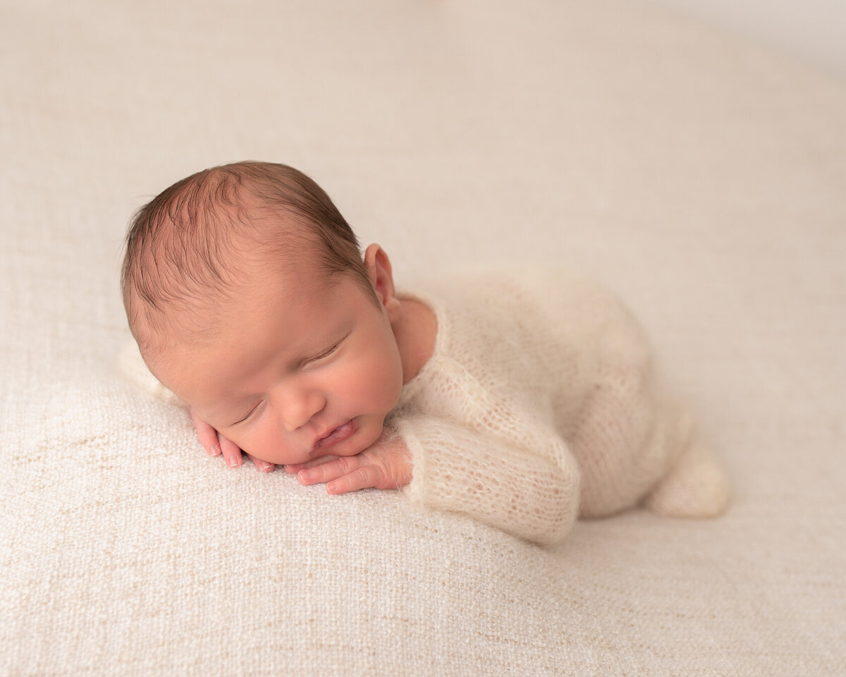 Chin on hands newborn Photo in Houston