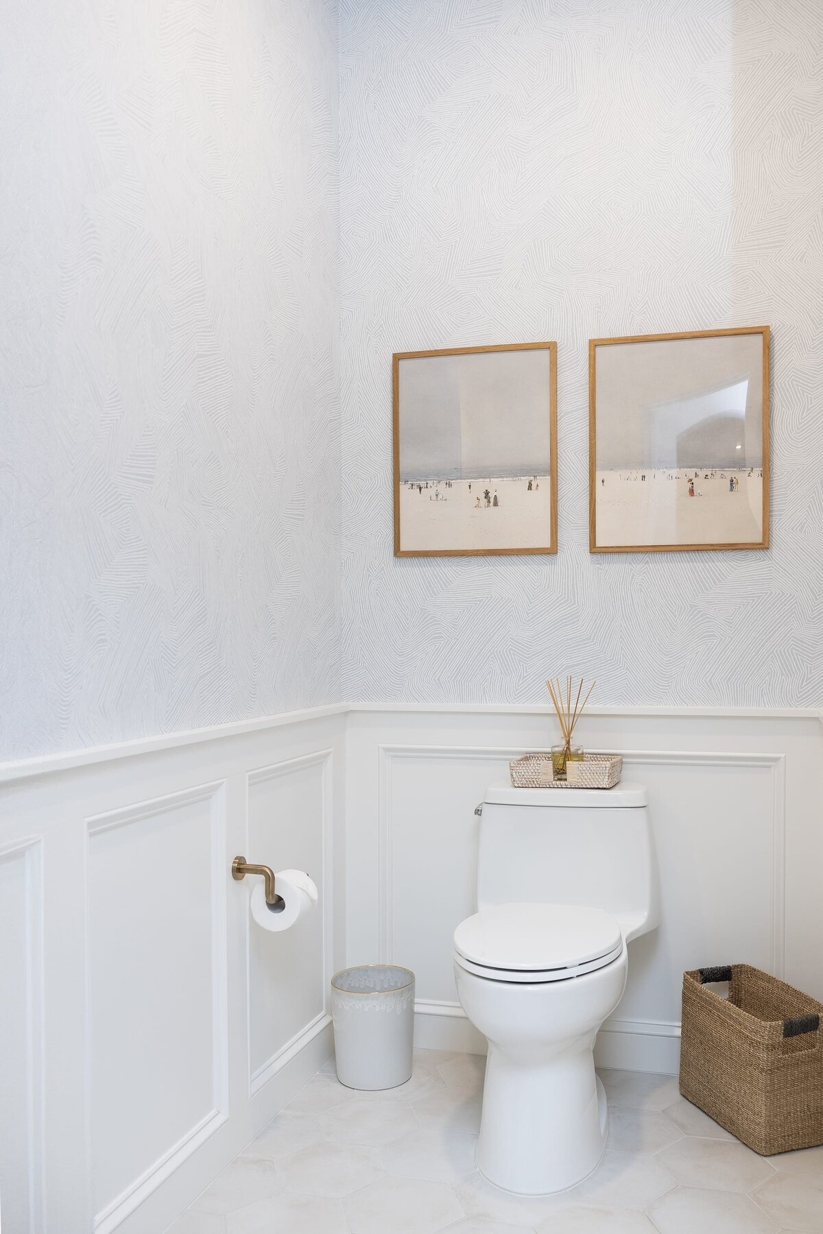 dewine design orlando interior designer contemporary coastal powder bathroom neutral wallpaper with wooden framed photos
