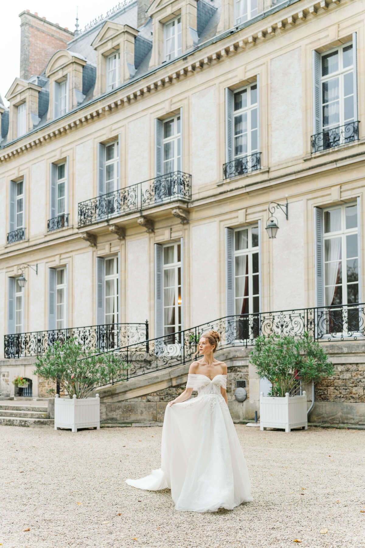 bride walking while holding her dress