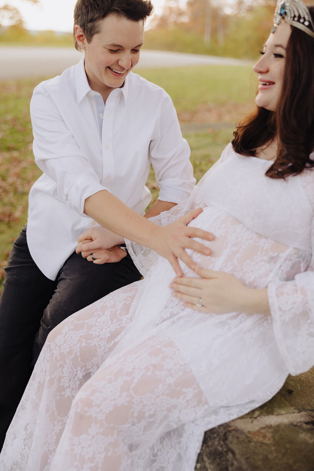 Couple resting hands on baby bump at Finger Lakes maternity session, NY