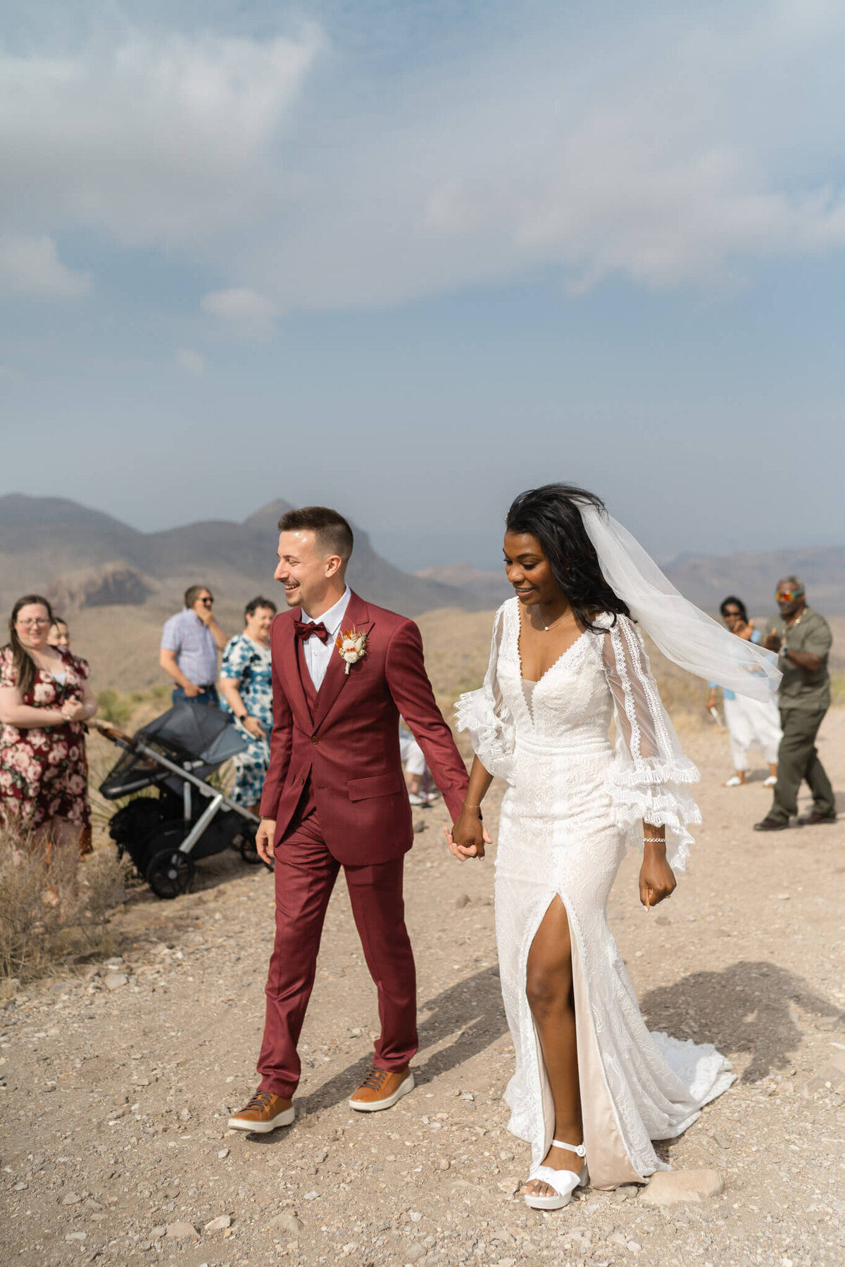 couple walks together through desert mountains