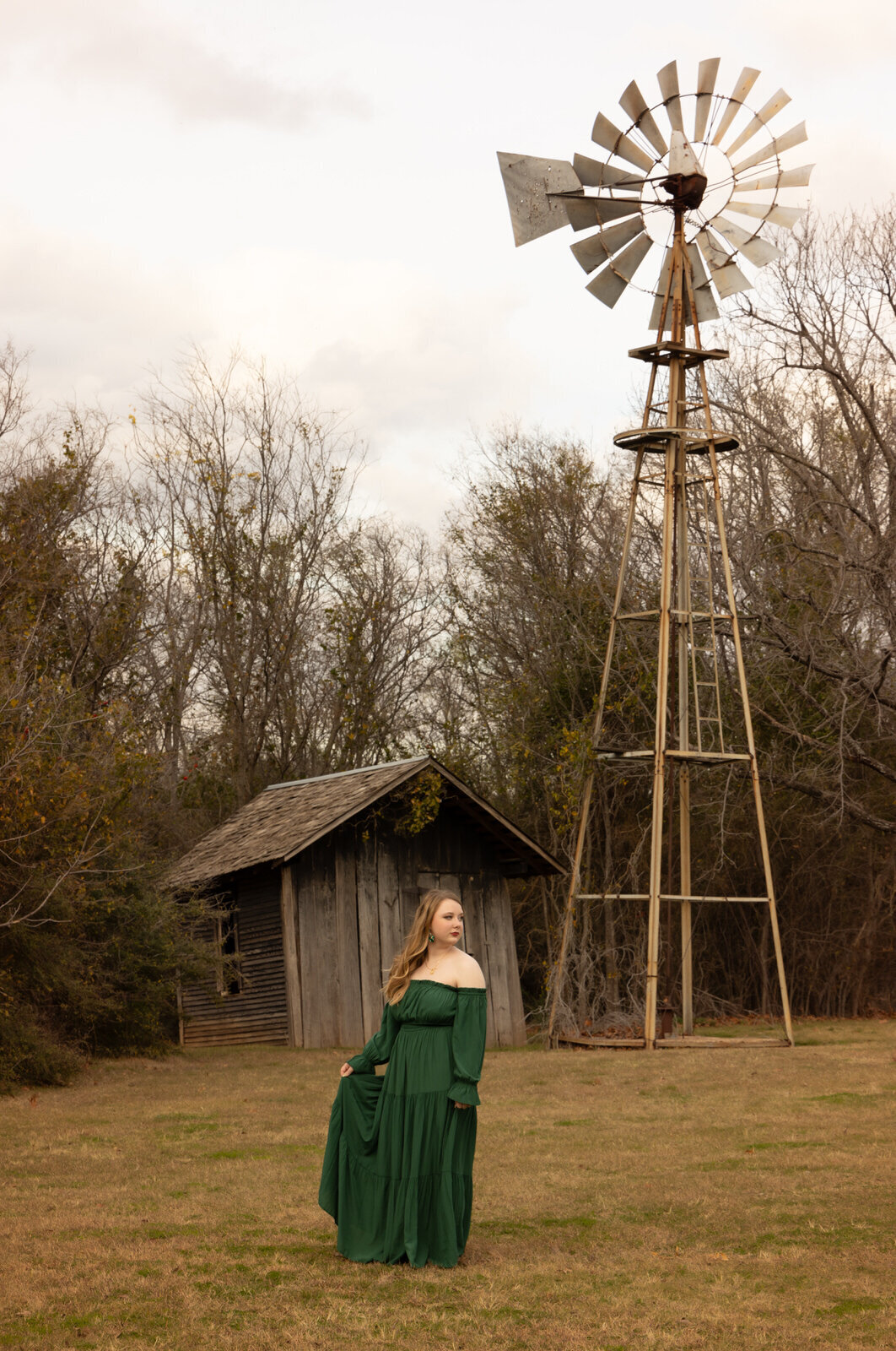girl-standing-in-green-dress-by-windwill