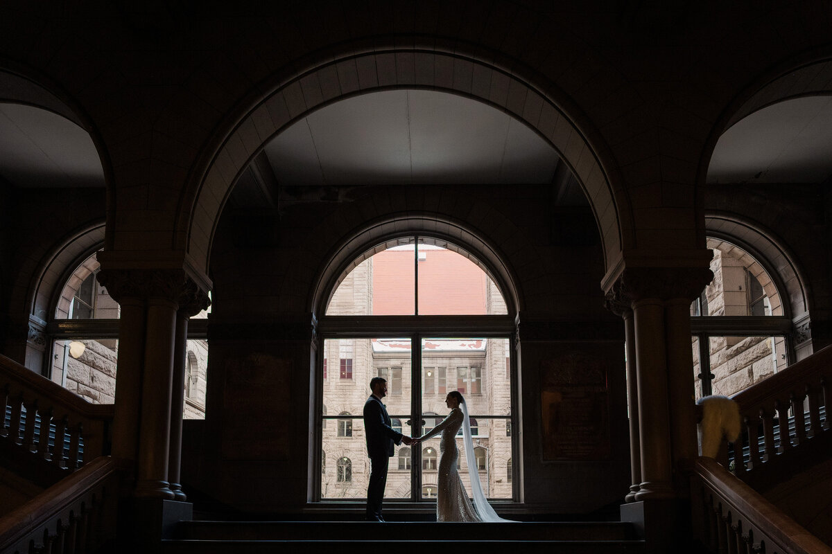 wedding photo moody and interesting inside of allegheny county courthouse window