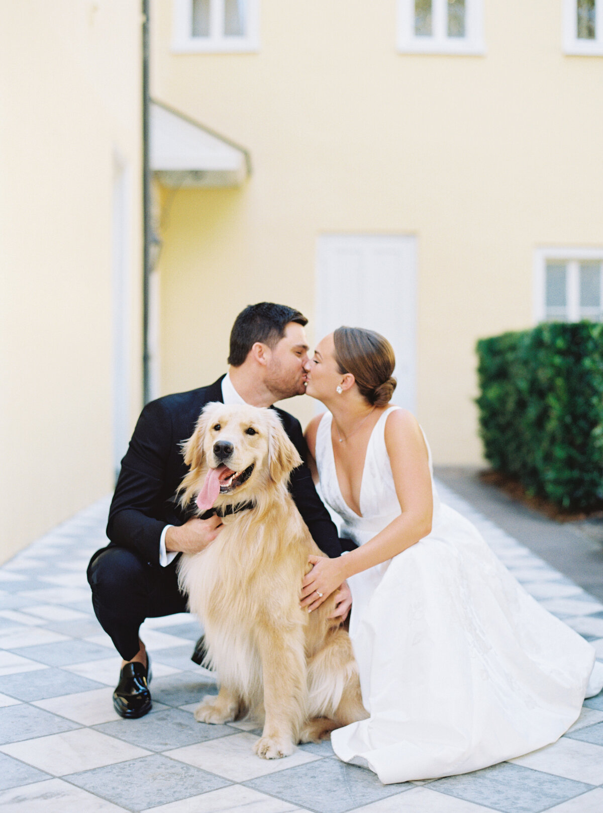 Charleston film photographer. Bride and groom portrait with their cute golden retriever at William Aiken House spring wedding in downtown Charleston.