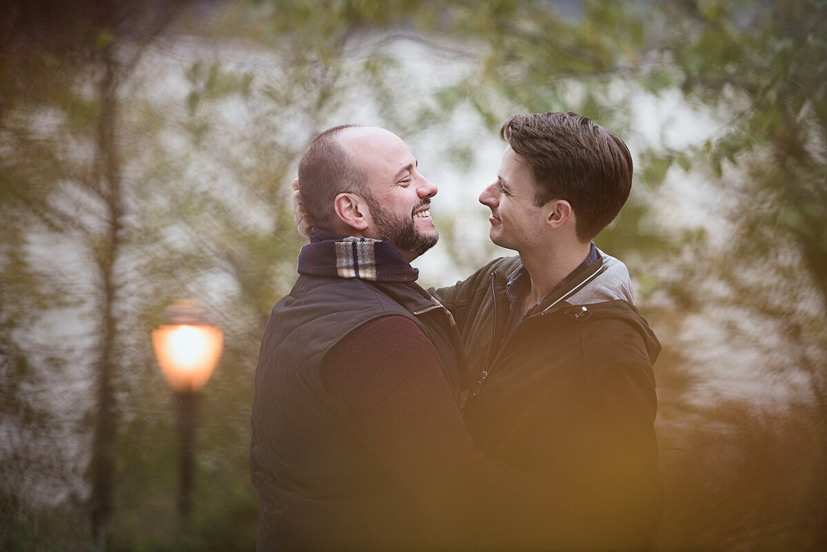 A couple hugging and about to kiss in a park