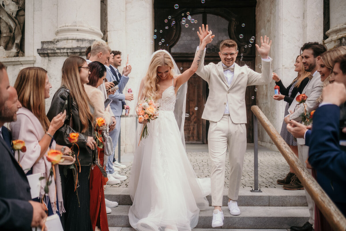 The wedding couple celebrate their vows with their guests when leaving the church.