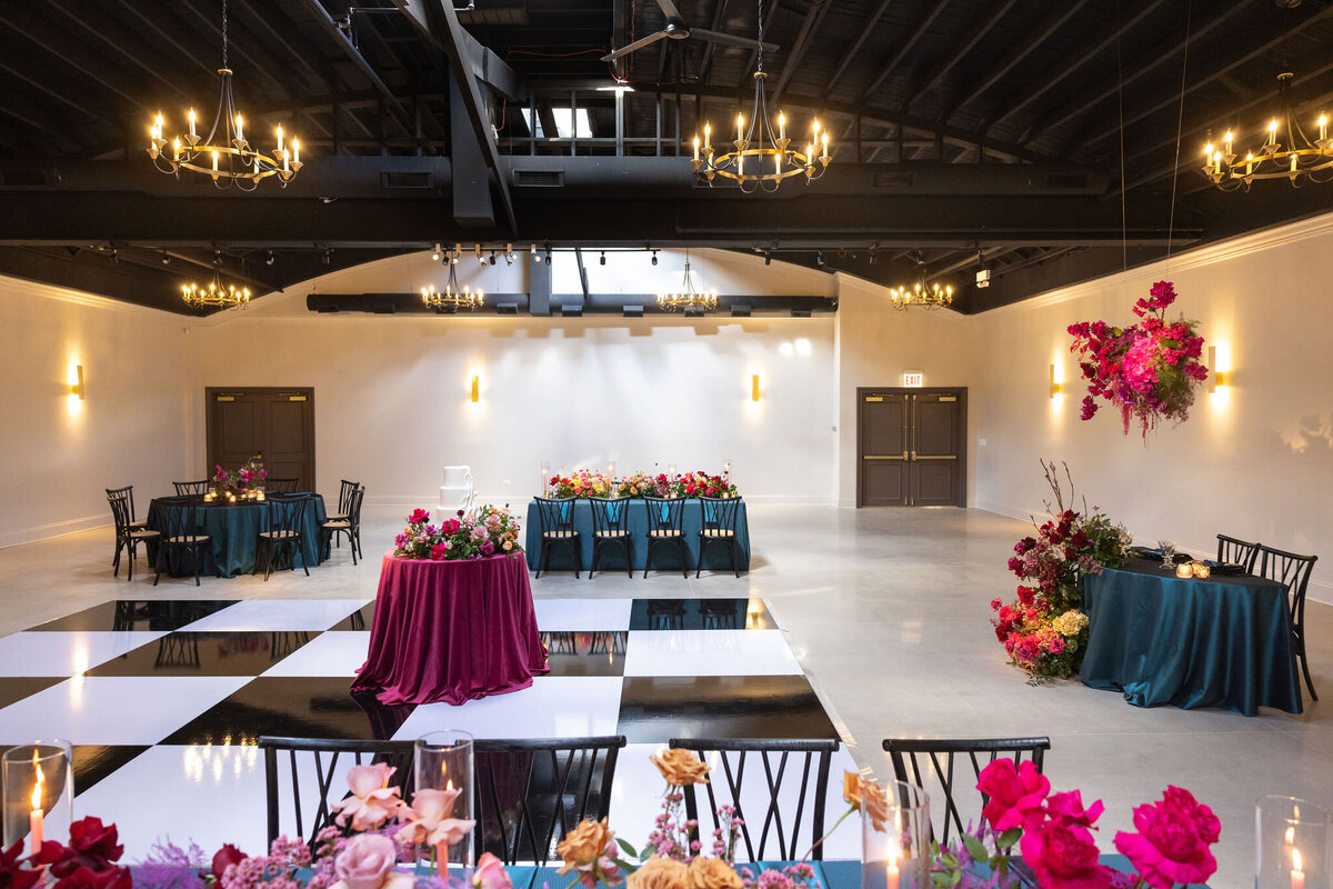 in house black and white dance floor in large reception space, timeless space with personalized floral and design