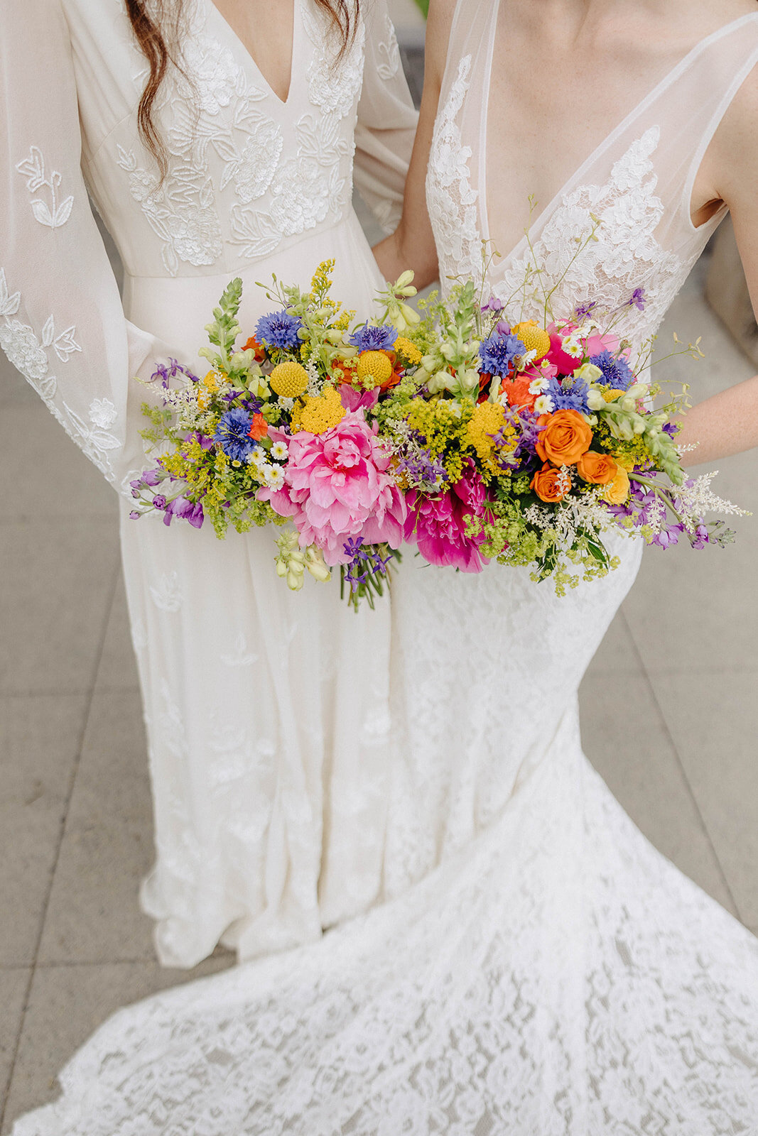 Brides holding colorful florals at Cornell University wedding