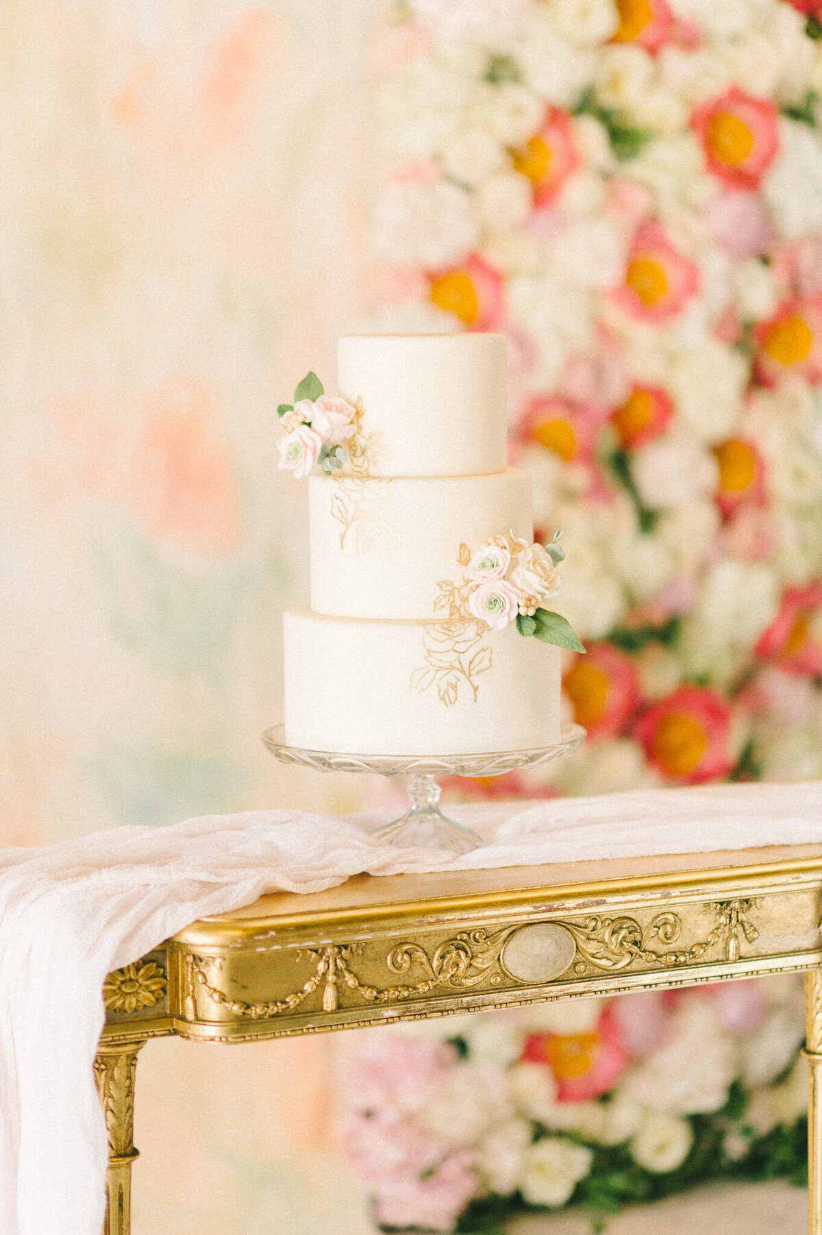 Classic, timeless three-tier white wedding cake with small simple pink roses and hand painted detail, created by Brianne Gabrielle Cakes,  elegant cakes & desserts in Edmonton, AB, featured on the Brontë Bride Vendor Guide.