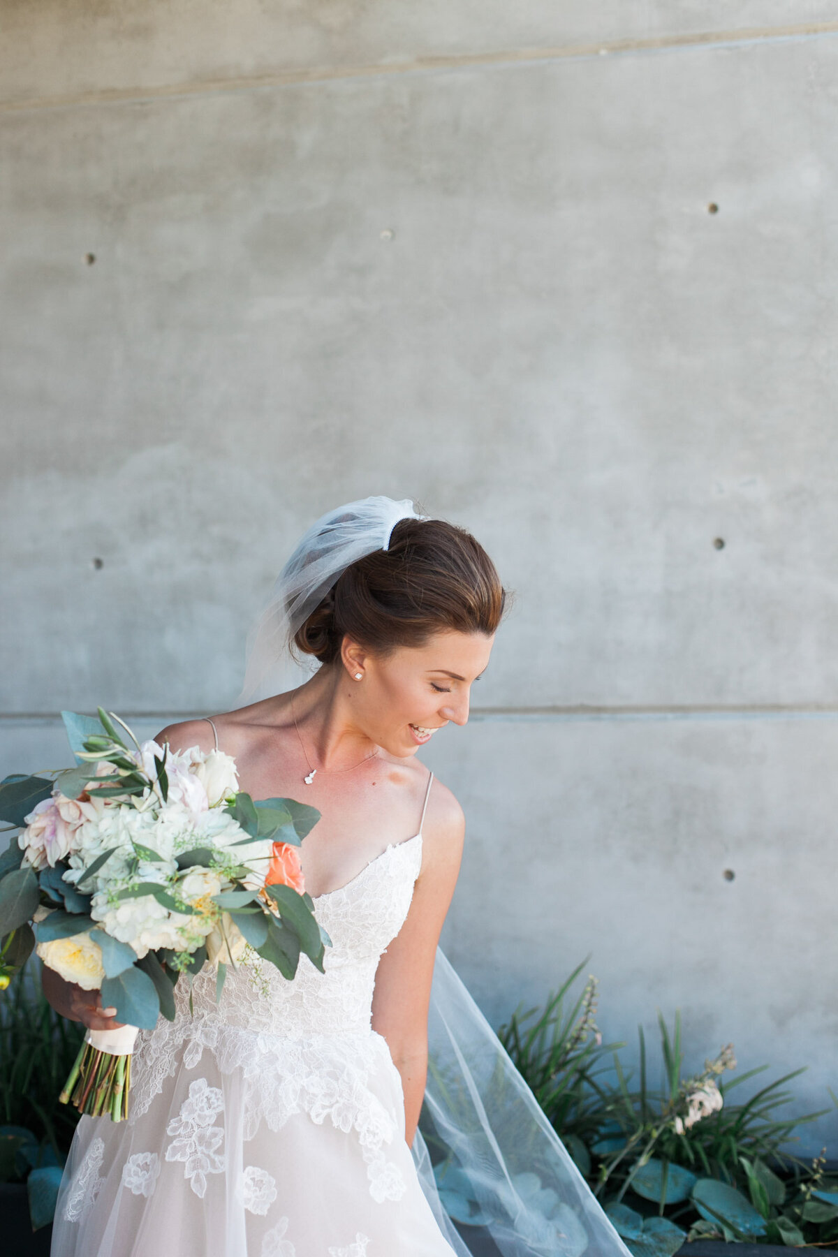 bride holding blum floral bouquet outside ponzi winery