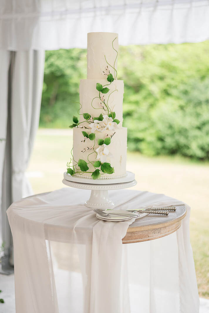 three tier white buttercream wedding cake with greenery, Hamilton ON wedding cakes