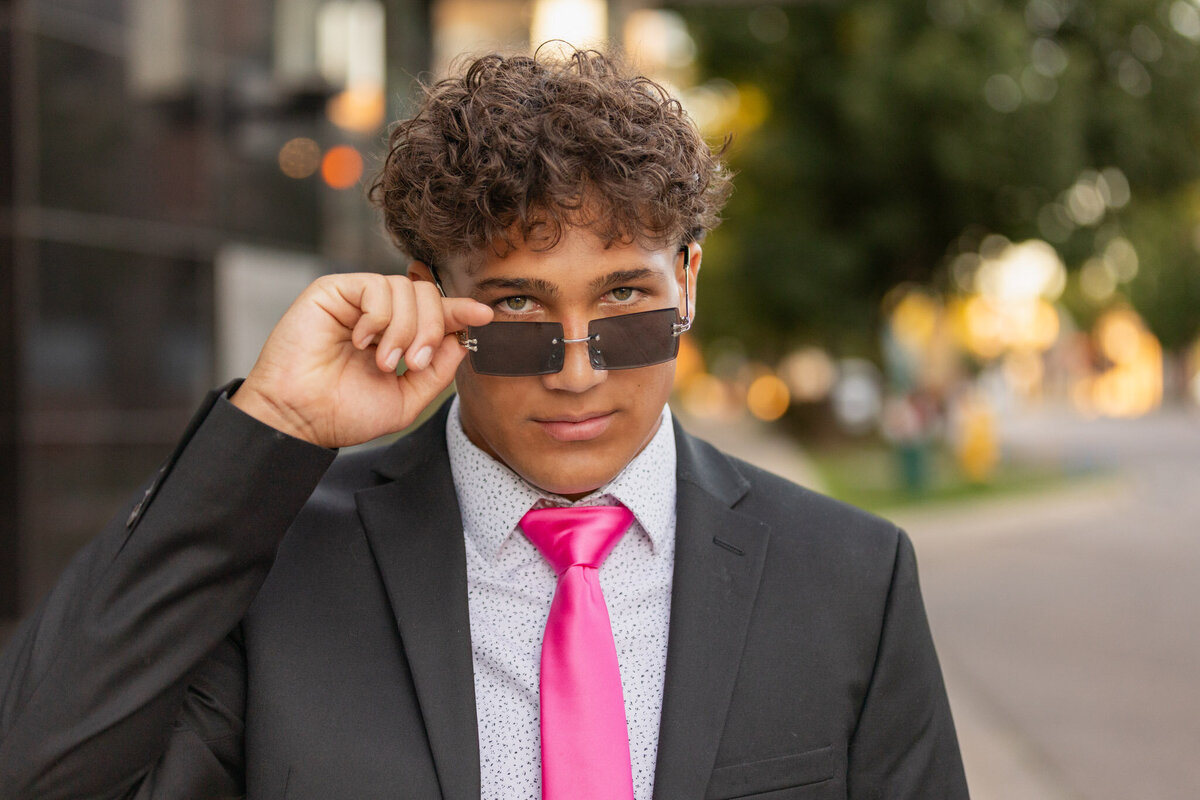 A senior guy looking over his sunglasses in Lawrence, KS