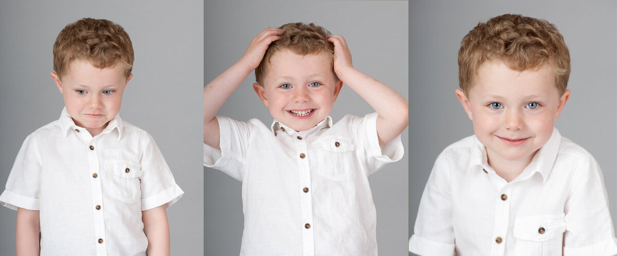 young boy smiling wearing a white shirt